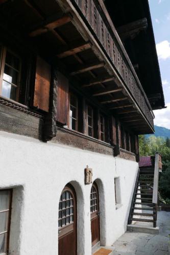 a building with a staircase and a door and a stair case at Apartment Tree-Tops- Chalet by Interhome in Gstaad