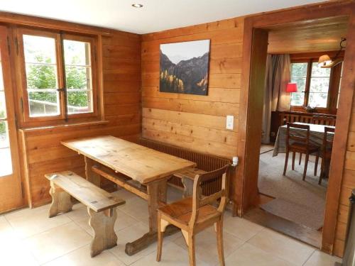 a dining room with a wooden table and chairs at Apartment Tree-Tops- Chalet by Interhome in Gstaad