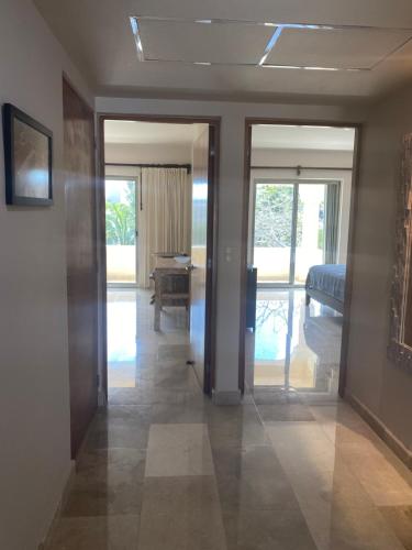 a hallway with a room with a bed and sliding glass doors at Sunset & Boat Watching Balcony SOL-QR-LTL-2025- 00508 in Puerto Aventuras