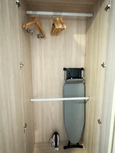 a bathroom with a toilet in a shower with curtains at Vuela Casa 2 in North Pattaya