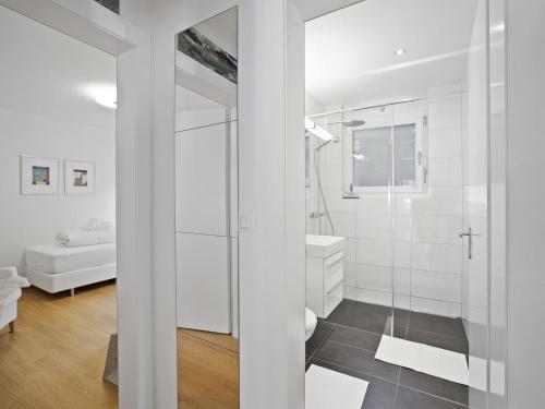 a bathroom with white walls and a glass shower at Apartment Liebrand by Interhome in Churwalden