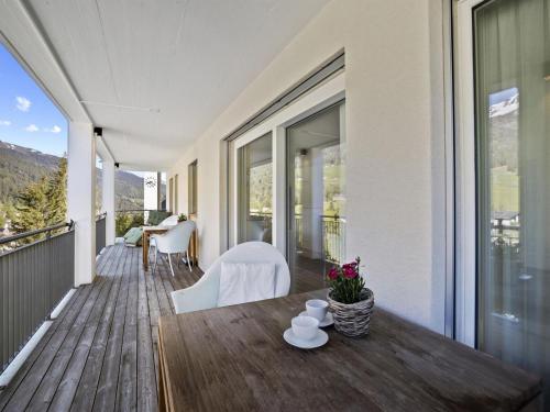a porch with a table and chairs on a deck at Apartment Liebrand by Interhome in Churwalden