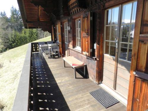 a porch of a house with chairs and windows at Apartment Guex by Interhome in Hornkessel