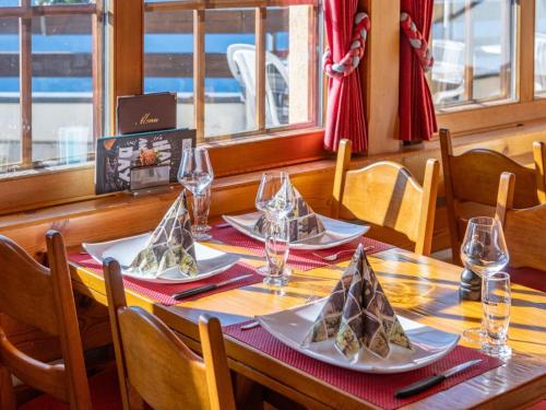 a wooden table with plates of food on it at Apartment Zurschmitten 15 1- UG Süd by Interhome in Riederalp