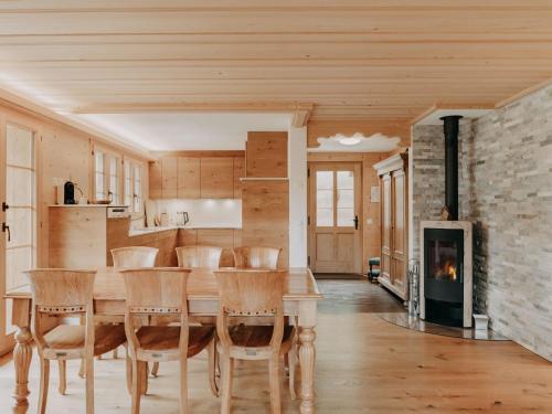 a dining room with a table and chairs and a fireplace at Apartment Giferblick by Interhome in Gstaad