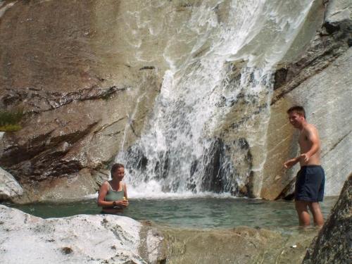 a man and a woman standing in a waterfall at Apartment Haus Alpenrose by Interhome in Saas-Almagell