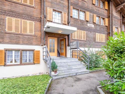 an old brick building with a staircase leading to the door at Apartment Résidence Sonnegg - Puric by Interhome in Zweisimmen