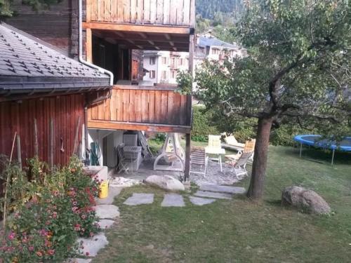 a house with a tree in the yard at Apartment ABC Ferienwohnung 3 1- OG Nord-Ost by Interhome in Fiesch