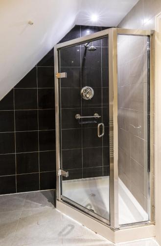 a shower with a glass door in a bathroom at The Kings Head Country Hotel in King's Lynn