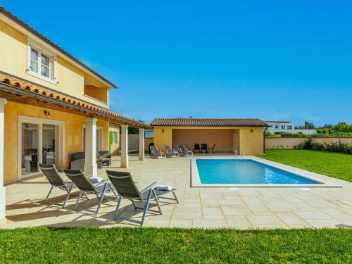 patio z krzesłami i basenem w obiekcie Villa Flori by Interhome w mieście Svetvinčenat