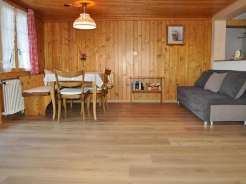a living room with a table and a couch at Apartment Kirchgasse 12 by Interhome in Grodoey
