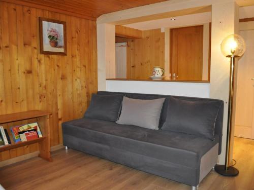a couch in a living room with a lamp at Apartment Kirchgasse 12 by Interhome in Grodoey