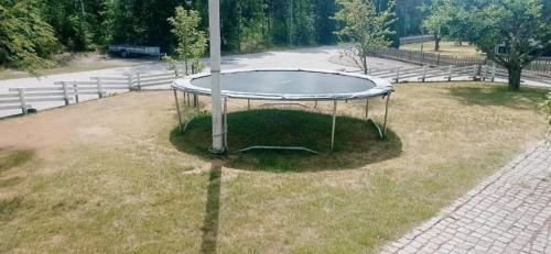 a trampoline in the grass with a pole at Cozy Forest View Villa with 5 Bedrooms in Jönköping
