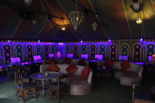 a room with a table and chairs and purple lights at Résidence Nardina Golden in Tetouan