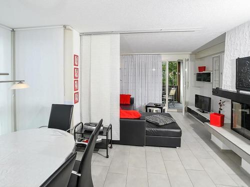 a living room with a couch and a table at Apartment Dorfstrasse 53c by Interhome in Engelberg