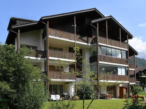 an apartment building with balconies on the side of it at Apartment Dorfstrasse 53c by Interhome in Engelberg