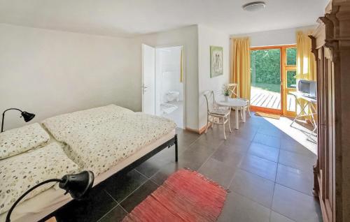 a bedroom with a bed and a table and a balcony at Ehemaliges Farmhaus Lehsten in Lehsten