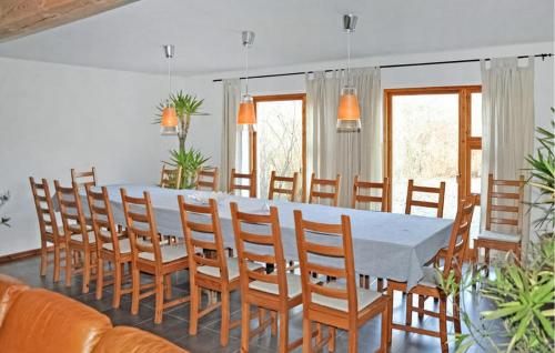 a dining room with a long table and chairs at Ehemaliges Farmhaus Lehsten in Lehsten