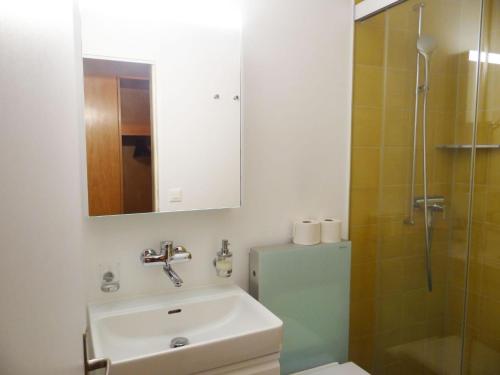 a bathroom with a sink and a shower at Apartment Sunnmatt West Wohnung 744 by Interhome in Engelberg