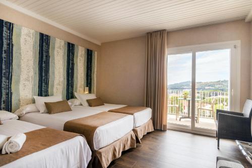 Posteľ alebo postele v izbe v ubytovaní Hotel Alga
