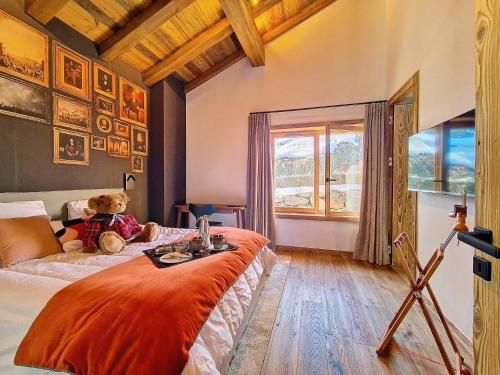a bedroom with a teddy bear sitting on a bed at Chalet La Panthère des Neiges in Saint-Martin-de-Belleville