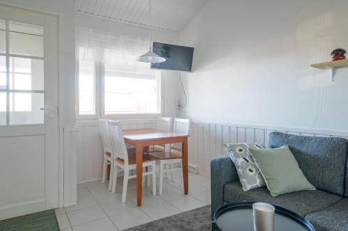 a living room with a table and a couch at Moonlight 214 in Levi