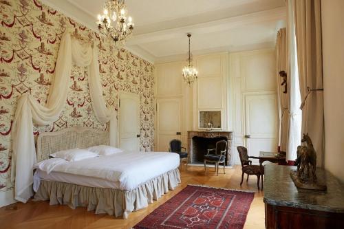 a bedroom with a bed and a desk and a piano at Château D'arry in Arry
