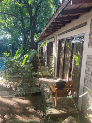 a chair sitting on the porch of a house at Hostal Casa Abierta in León