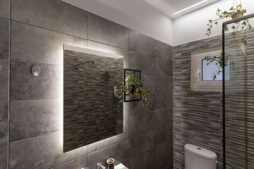 a bathroom with a shower and a mirror at Luxury rooftop in Larisa
