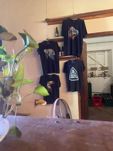 a group of shirts hanging on a wall at Hostal Casa Abierta in León