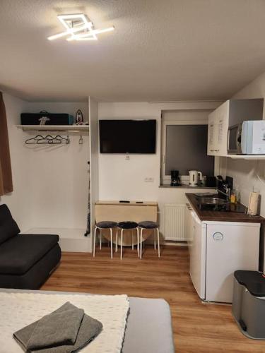 a kitchen and a living room with a couch and a table at Stuttgart City Apartment A in Stuttgart