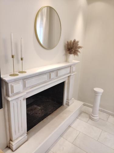 a white fireplace with a mirror on the wall at TERRA LUXURY HOME in Drama