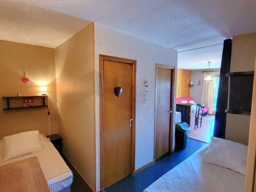 - une chambre avec un lit et une porte dans l'établissement Charmant studio 4 pers. au pied des pistes - Balcon Sud Ouest, parking, centre station - FR-1-393-160, à Saint-Michel-de-Chaillol