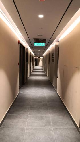 a hallway in a building with a long corridor at BORNEO SUTERA BAY Homestay Services in Kota Kinabalu