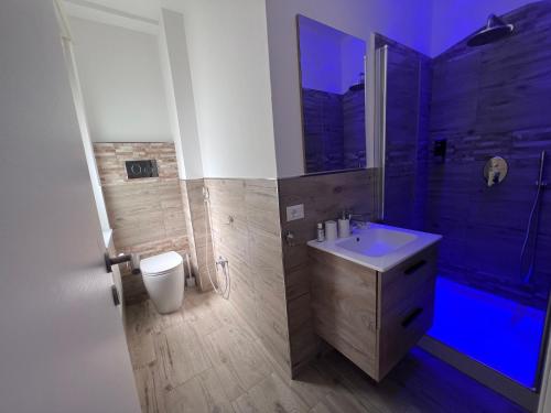a bathroom with a toilet and a sink and a shower at Hierá Guest House in Milazzo