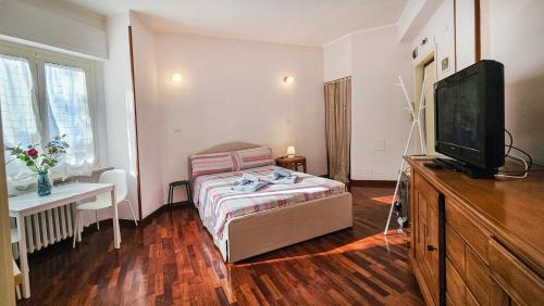a bedroom with a bed and a flat screen tv at La voce del porto in Ancona