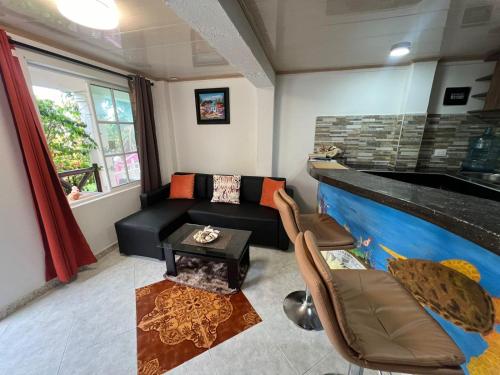 a living room with a couch and a fireplace at Posada Ashanty in Providencia
