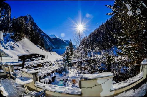 a snow covered mountain with the sun in the sky at AlpinDesign Kaunertal in Kaunertal
