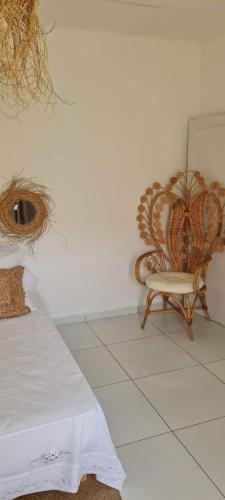a bedroom with a chair next to a wall at Kaz KAFE in Mamoudzou