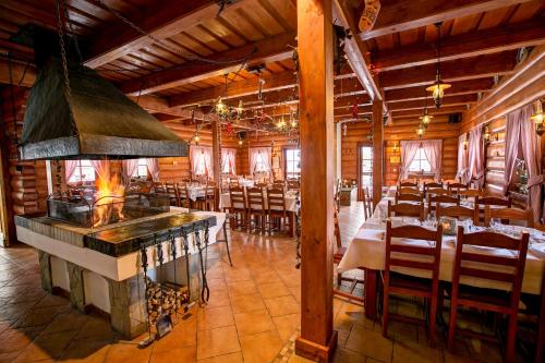 a large dining room with tables and a stove at Hotel Koliba Greta in Liptovská Sielnica