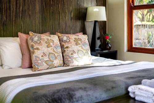 a bedroom with a bed with pillows and a window at Leipzig Country House & Winery in Nuy