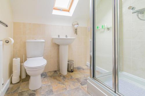 a bathroom with a toilet and a sink and a shower at 3 Bedroom Contractor House By Your Lettings Short Lets & Serviced Accommodation Peterborough With Free WiFi and Parking in Peterborough