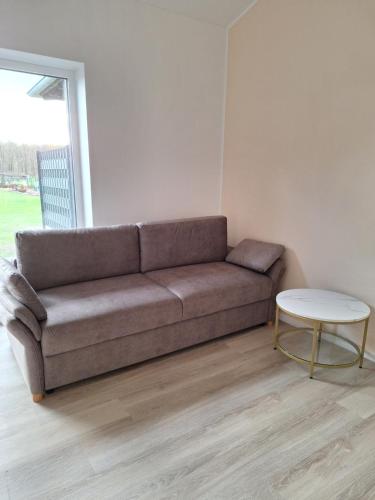 a brown couch in a living room with a table at Villa Rustica in Xanten