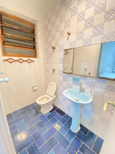a bathroom with a sink and a toilet at Santorini House in Guarujá