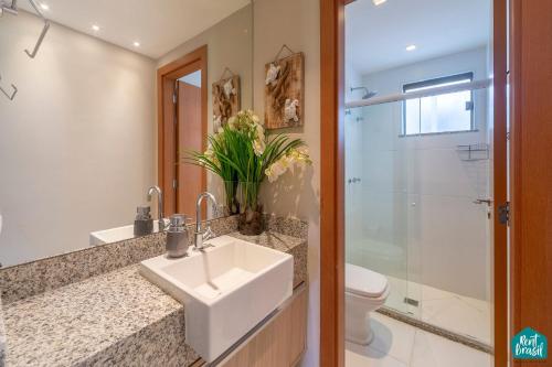 a bathroom with a sink and a toilet at Ykutiba Imbassaí - Apartamento Superior - I103 in Imbassai