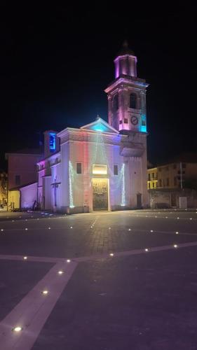 a building with a clock tower at night at Appartamento vacanze mare Loano in Loano