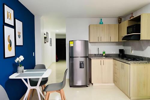 a kitchen with a refrigerator and a table and chairs at 9903 Vista al sur de la ciudad para 2 in Envigado