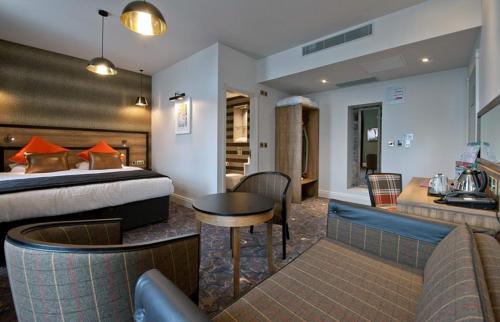 a hotel room with a bed and a table at The Saltoun Inn in Fraserburgh