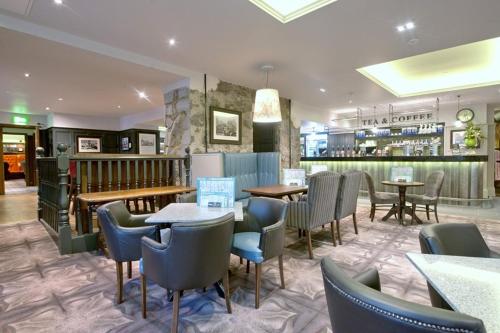 a restaurant with tables and chairs and a bar at The Saltoun Inn in Fraserburgh