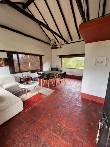 a living room with a couch and a table at Hotel, Glampings y Cabaña Magic Bungalow in Villa de Leyva